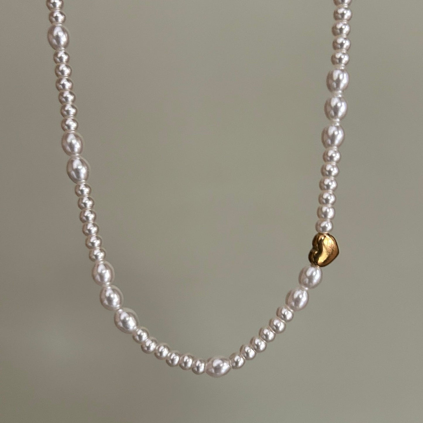 Pearl necklace with a gold heart pendant